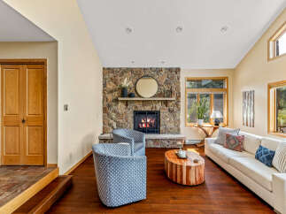 This stunning living room features a cozy stone fireplace, perfect for relaxing evenings.