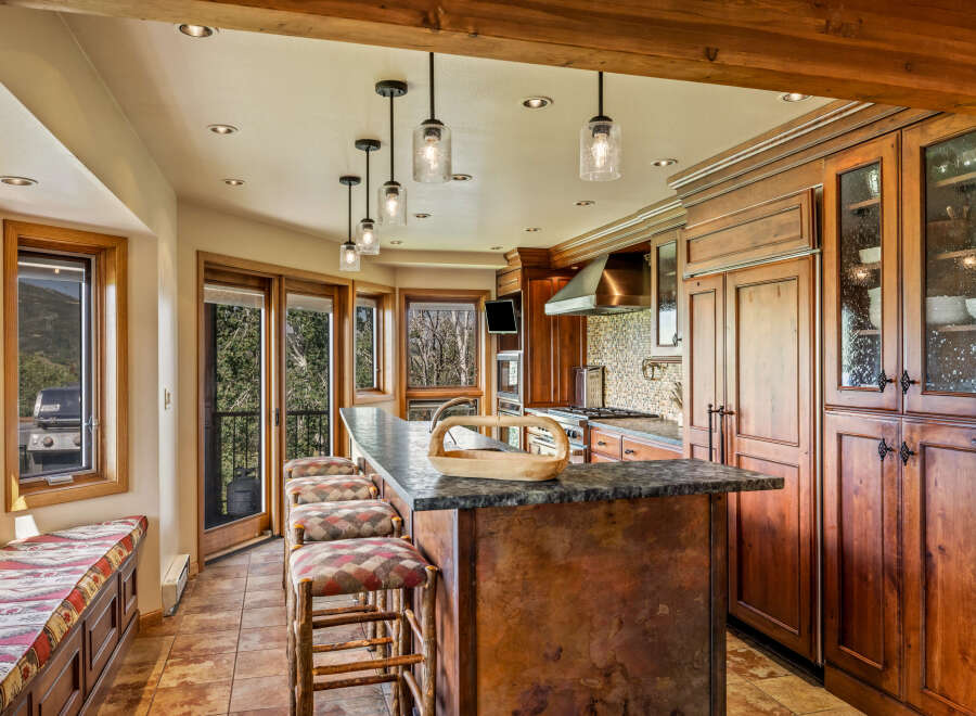 This stunning kitchen boasts a seamless blend of rustic charm and modern elegance.