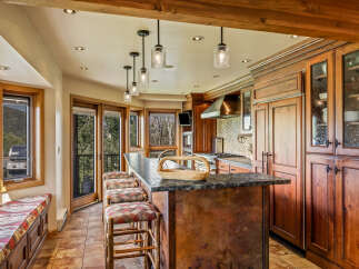 This stunning kitchen boasts a seamless blend of rustic charm and modern elegance.