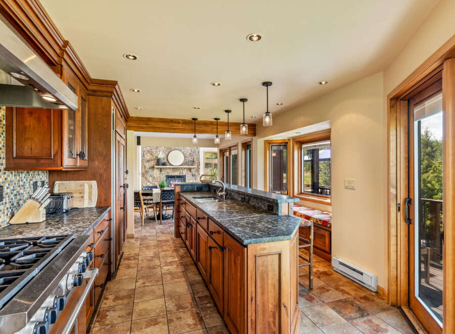 This stunning kitchen boasts custom cabinetry, granite countertops, and top-of-the-line appliances, perfect for culinary enthusiasts.