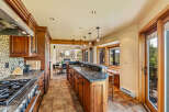 This stunning kitchen boasts custom cabinetry, granite countertops, and top-of-the-line appliances, perfect for culinary enthusiasts.