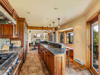 This stunning kitchen boasts custom cabinetry, granite countertops, and top-of-the-line appliances, perfect for culinary enthusiasts.