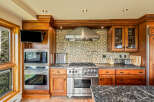 This stunning kitchen boasts custom cabinetry and high-end stainless steel appliances, perfect for the discerning chef.