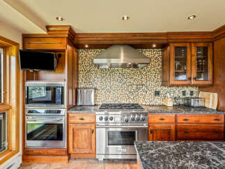 This stunning kitchen boasts custom cabinetry and high-end stainless steel appliances, perfect for the discerning chef.