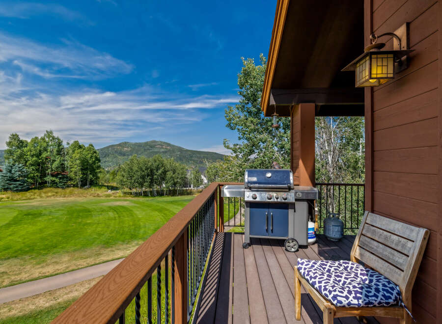 Enjoy breathtaking views from this stunning property! This home features a spacious deck with a grill, perfect for outdoor entertaining.
