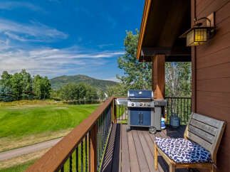 Enjoy breathtaking views from this stunning property! This home features a spacious deck with a grill, perfect for outdoor entertaining.