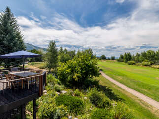Enjoy breathtaking views from this stunning property! This home features a spacious deck with a dining area, perfect for entertaining or relaxing.