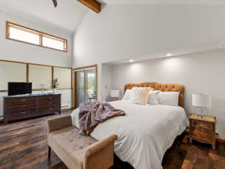 Experience luxury in this stunning bedroom featuring a plush bed, perfect for relaxation.