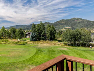 Enjoy stunning views of the golf course and surrounding mountains from this beautiful property.