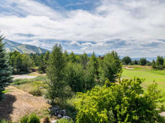 Enjoy breathtaking views of the mountains and lush greenery from this stunning property.