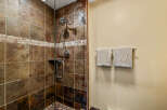 Step into a luxurious bathroom featuring a stunning tiled shower.