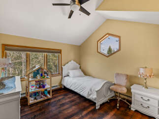 This charming bedroom features a cozy single bed, perfect for a child or guest.