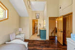 Step into this inviting bedroom, featuring stunning hardwood floors and a unique architectural design.