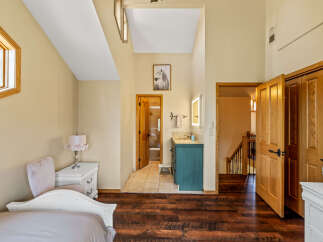 Step into this inviting bedroom, featuring stunning hardwood floors and a unique architectural design.