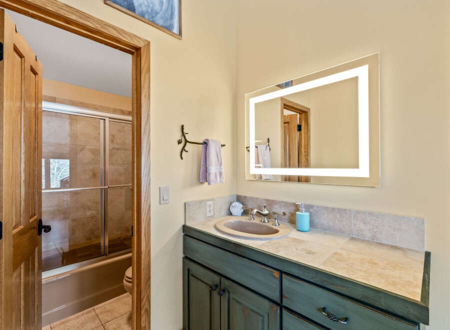 This stunning bathroom features a modern vanity with a beautiful countertop and a stylish sink.