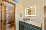 This stunning bathroom features a modern vanity with a beautiful countertop and a stylish sink.