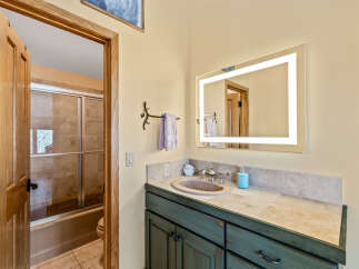 This stunning bathroom features a modern vanity with a beautiful countertop and a stylish sink.