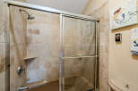 Step into a beautifully designed bathroom featuring a modern shower with a sliding glass door.