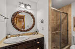 This stunning bathroom features a beautiful vanity with a large, ornate mirror, perfect for getting ready in style.