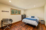 This cozy bedroom features a comfortable bed with a stylish blue throw and decorative pillow, perfect for relaxation.