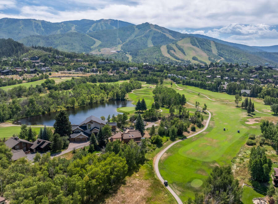 This stunning property boasts a picturesque golf course and a serene lake, offering a perfect blend of luxury and natural beauty.