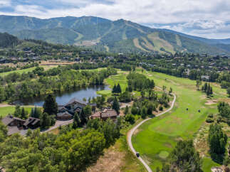 This stunning property boasts a picturesque golf course and a serene lake, offering a perfect blend of luxury and natural beauty.