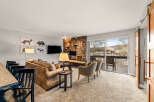 This stunning property features a cozy living room with a stone fireplace, perfect for relaxing evenings.