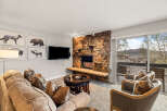 This cozy living room features a stunning stone fireplace, perfect for those chilly evenings.