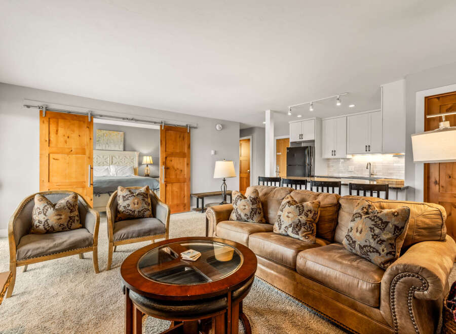 Step into luxury with this stunning property! Featuring a spacious living area with a cozy leather sofa and stylish armchairs, perfect for relaxing or entertaining.