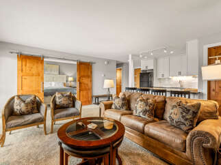 Step into luxury with this stunning property! Featuring a spacious living area with a cozy leather sofa and stylish armchairs, perfect for relaxing or entertaining.