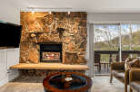 Experience cozy living in this stunning property featuring a beautiful stone fireplace, perfect for those chilly evenings.