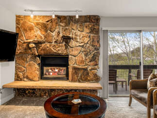Experience cozy living in this stunning property featuring a beautiful stone fireplace, perfect for those chilly evenings.