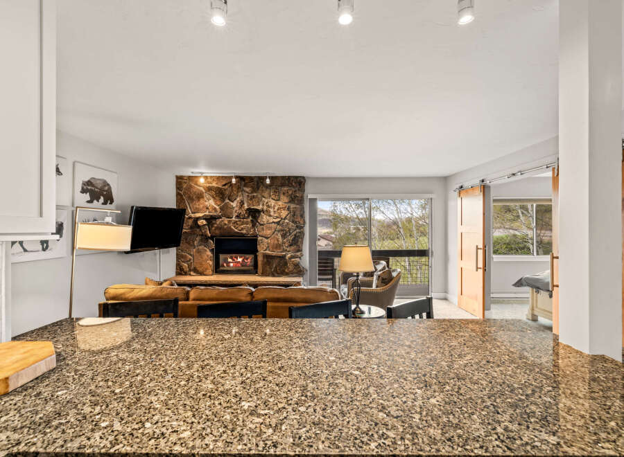 Step into luxury with this stunning property featuring a cozy fireplace and a modern kitchen.
