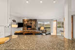 Step into luxury with this stunning property featuring a cozy fireplace and a modern kitchen.