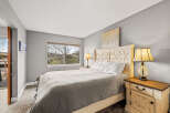 This cozy bedroom features a comfortable bed with a stylish headboard and a neutral color palette.