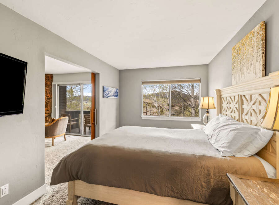 Step into this inviting bedroom, featuring a cozy bed and a serene ambiance.