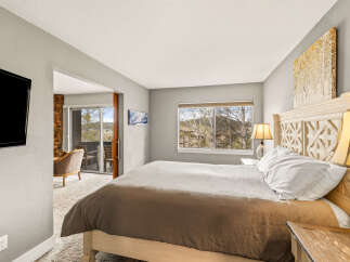 Step into this inviting bedroom, featuring a cozy bed and a serene ambiance.