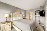 This cozy bedroom features a comfortable bed with a stylish headboard, perfect for a relaxing retreat.