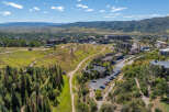 An aerial view showcases a stunning mountain resort town, perfect for a luxurious getaway.