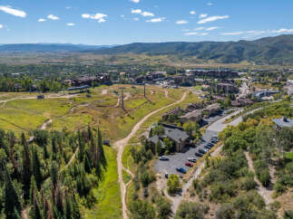 An aerial view showcases a stunning mountain resort town, perfect for a luxurious getaway.
