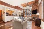 This stunning property boasts a cozy living room with a stone fireplace and a large flat-screen TV, perfect for relaxing evenings.