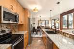 Step into this stunning kitchen, boasting beautiful wooden cabinetry and sleek stainless steel appliances.