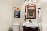 This charming bathroom features a stylish vanity with a sleek sink and a dark wood finish.