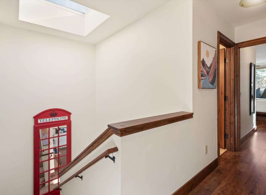This stunning property features a unique and charming interior, including a decorative red telephone booth.
