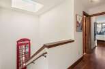 This stunning property features a unique and charming interior, including a decorative red telephone booth.