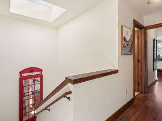 This stunning property features a unique and charming interior, including a decorative red telephone booth.