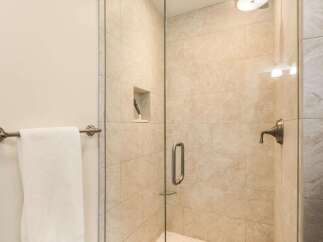 Step into a luxurious bathroom featuring a modern glass-enclosed shower.