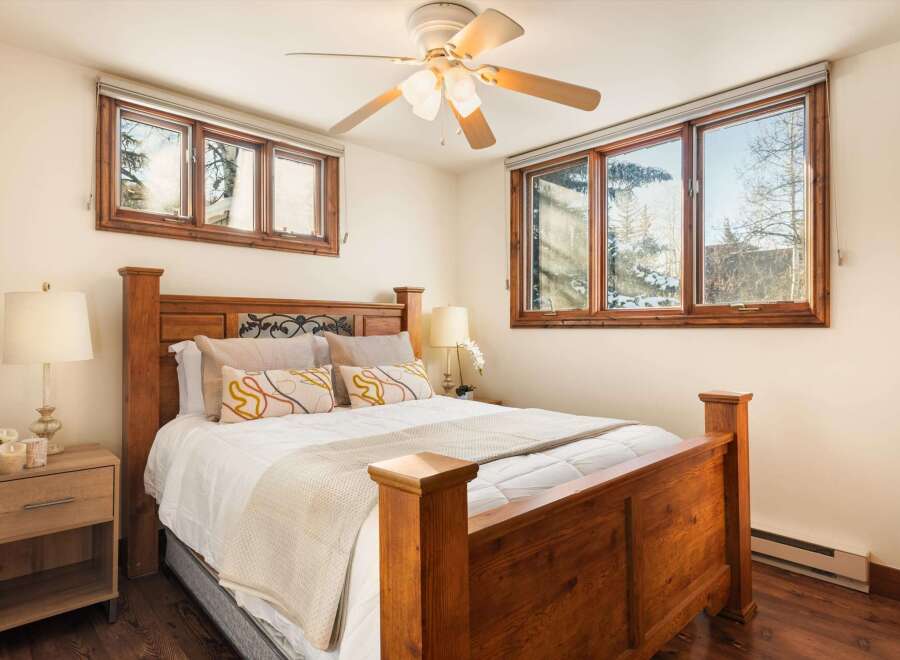 This inviting bedroom features a cozy bed with a wooden frame, perfect for a restful night's sleep.