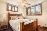 This inviting bedroom features a cozy bed with a wooden frame, perfect for a restful night's sleep.