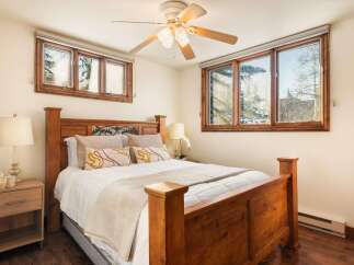 This inviting bedroom features a cozy bed with a wooden frame, perfect for a restful night's sleep.
